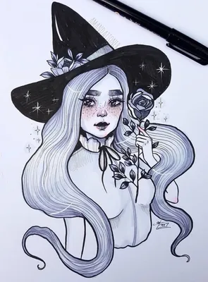 Фото Юная голубоглазая ведьмочка в шляпе с магическим шаром